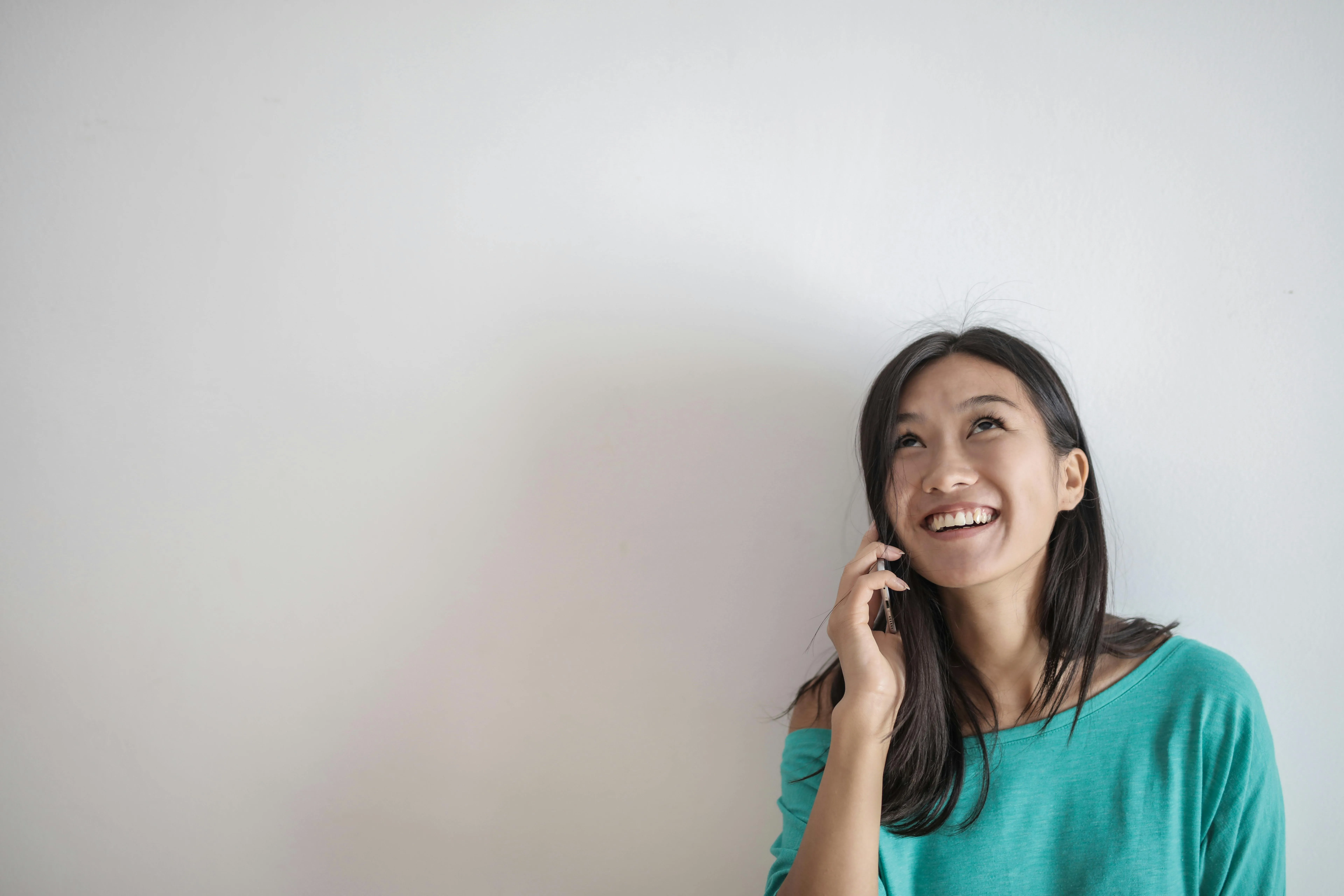Women smiling whilst on the phone