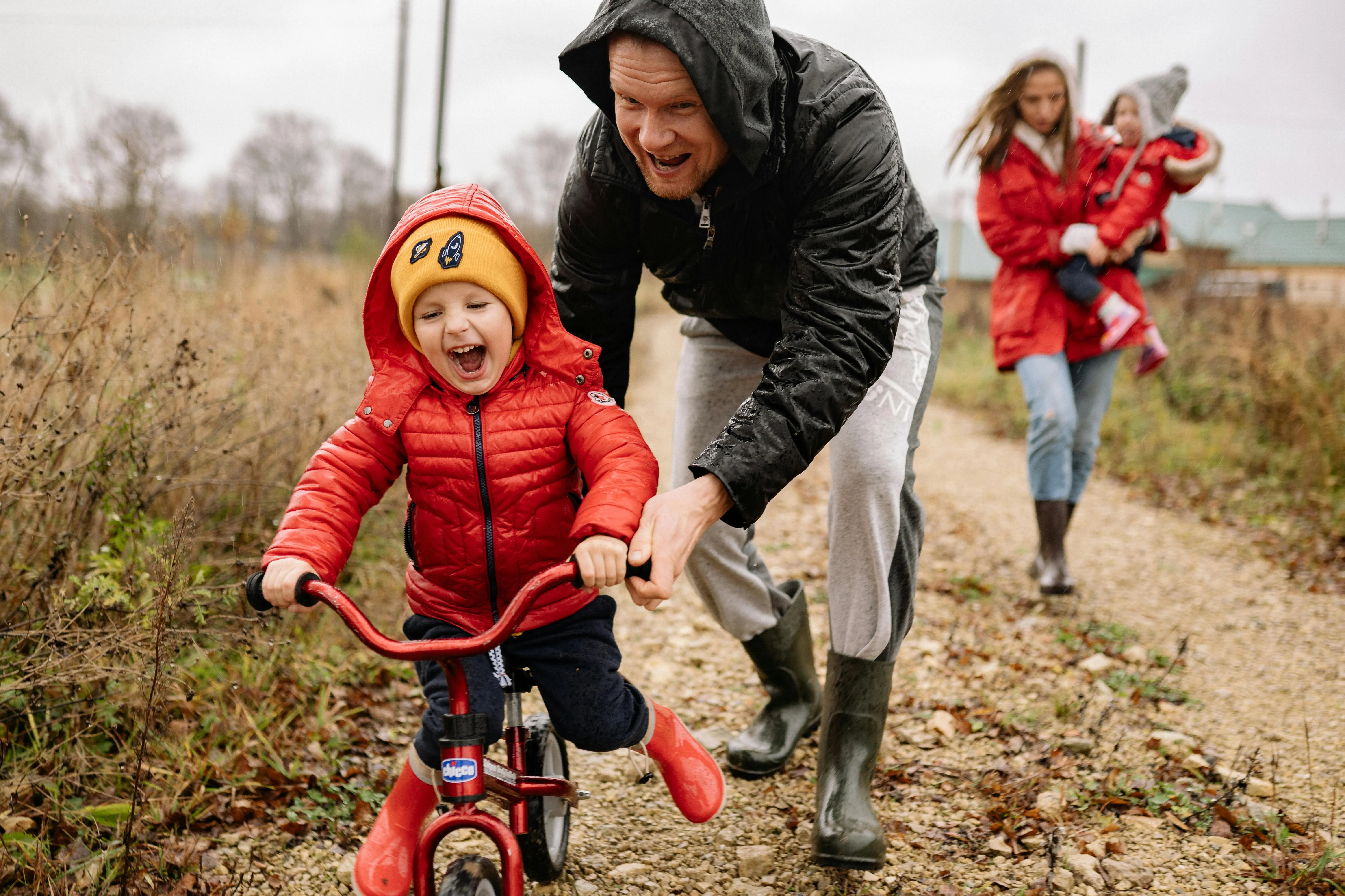 A father and son enjoying the rain