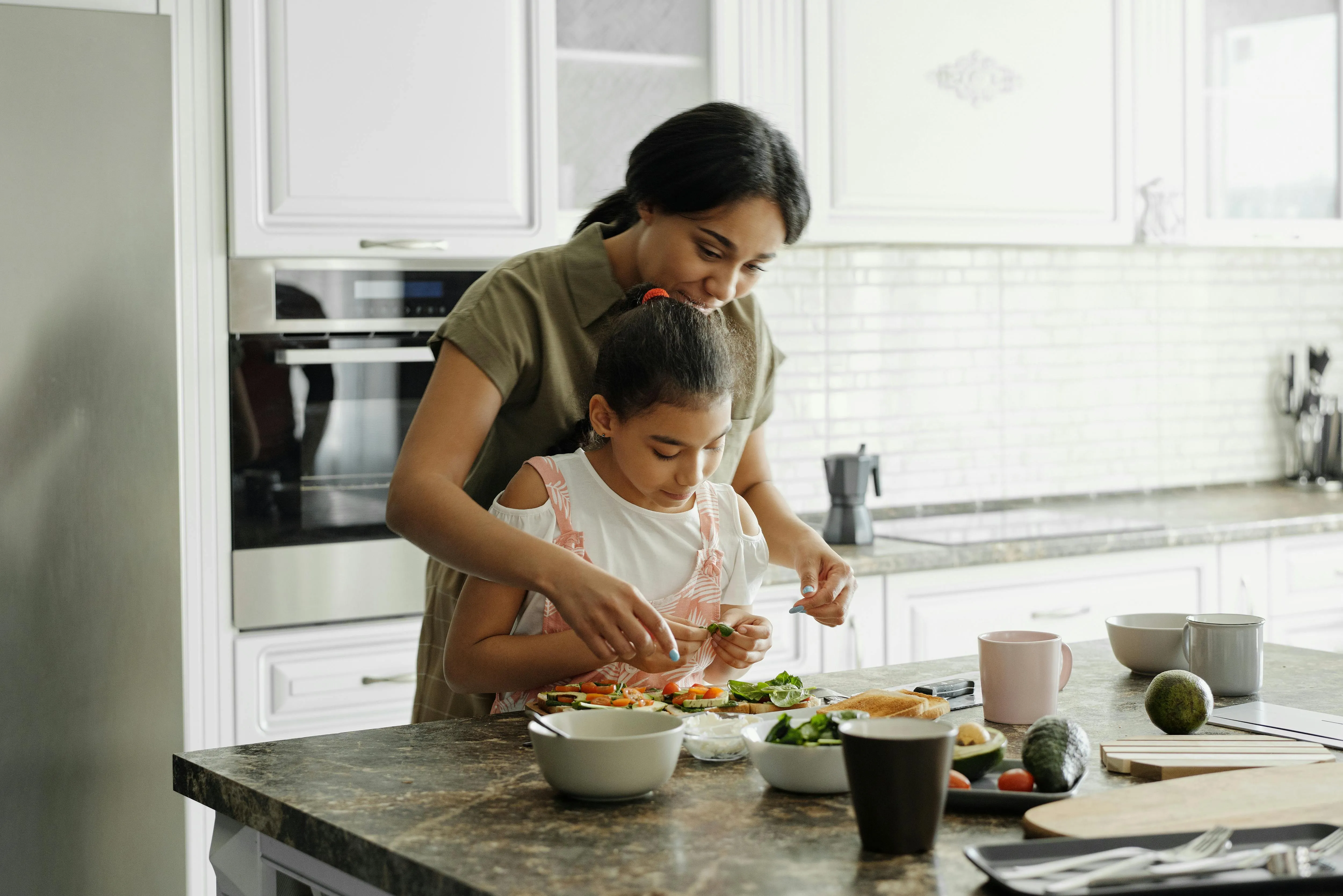 A woman and her child cooking together